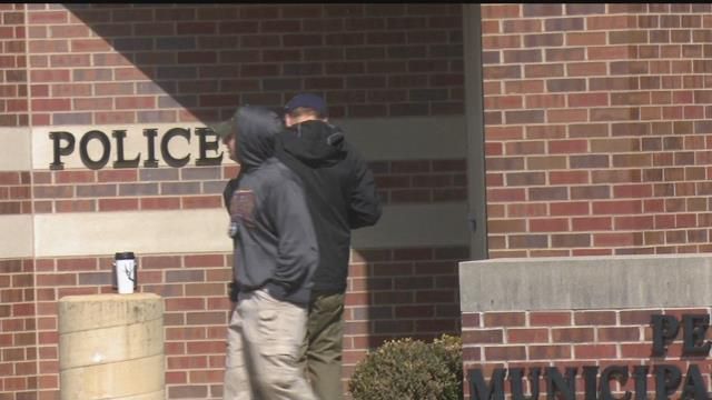 Police seen outside Pekin City Hall during a recent pipe bomb scare.