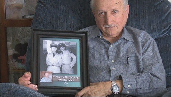 Spec-4 Al Kollar poses with his prized photograph of himself and Elvis